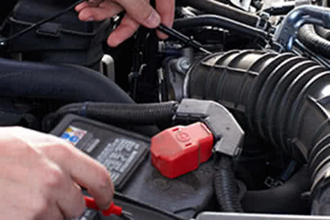 photo of battery voltage tests during automotive electrical service